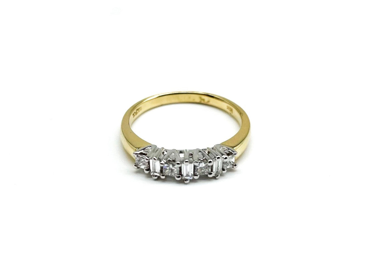 .20 Point Round Brilliant Cut and .12 Point Baguette Cut Diamond Ring