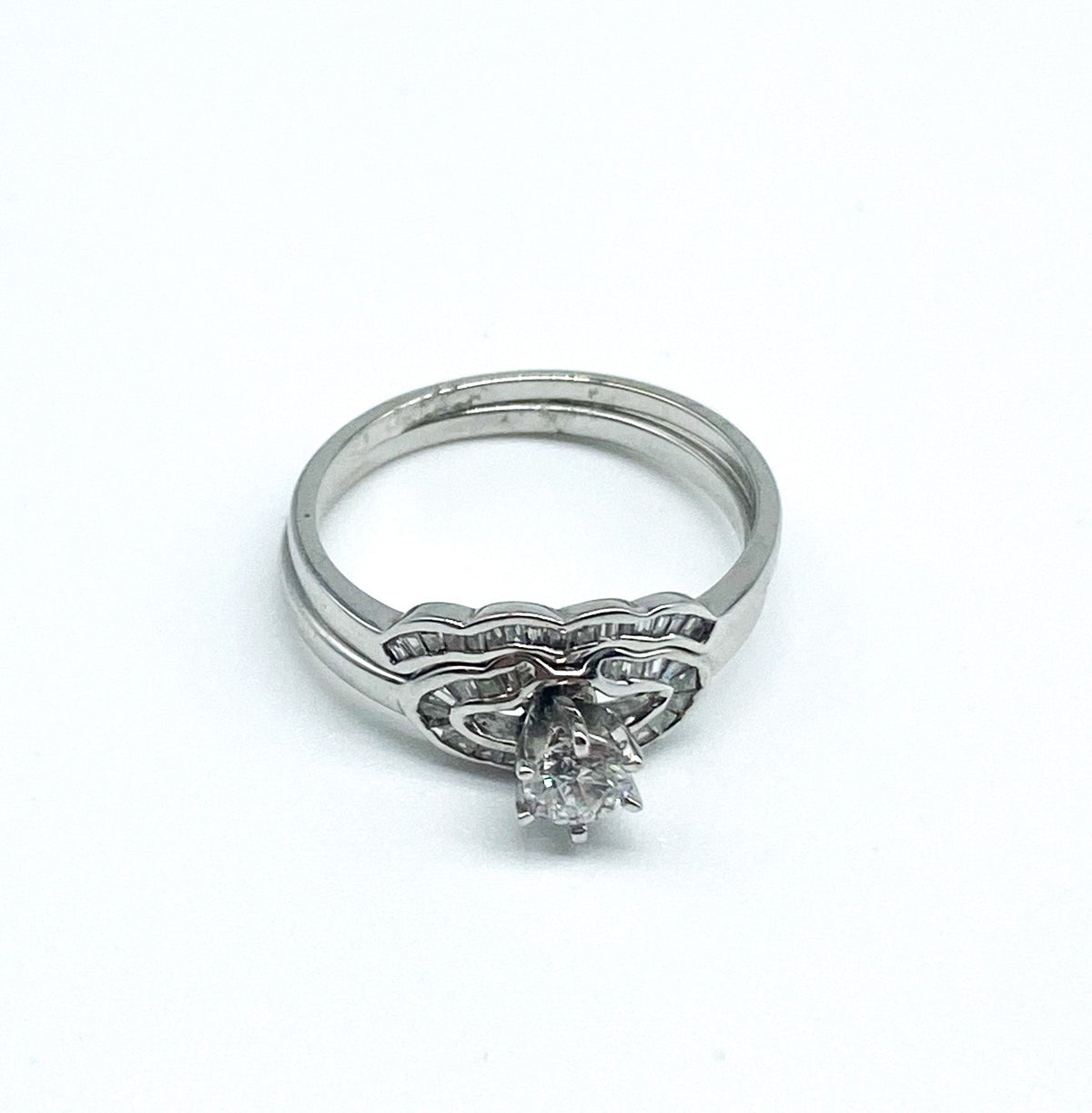 .26 Point Round Brilliant Cut and .28 Point Baguette Cut Diamond Ring