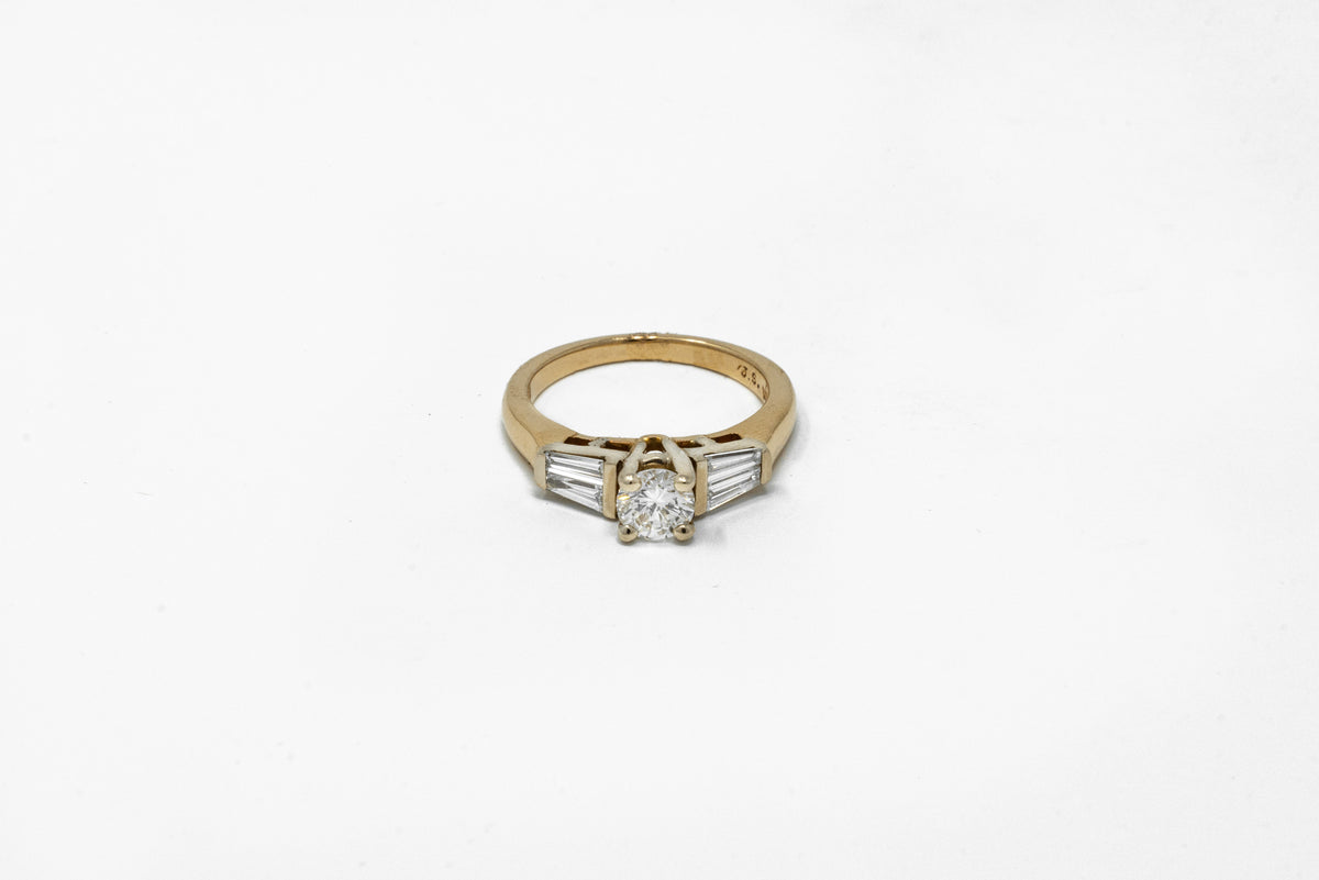 .57 point Round Brilliant Cut and .50 Tapered Baguette Diamond Ring