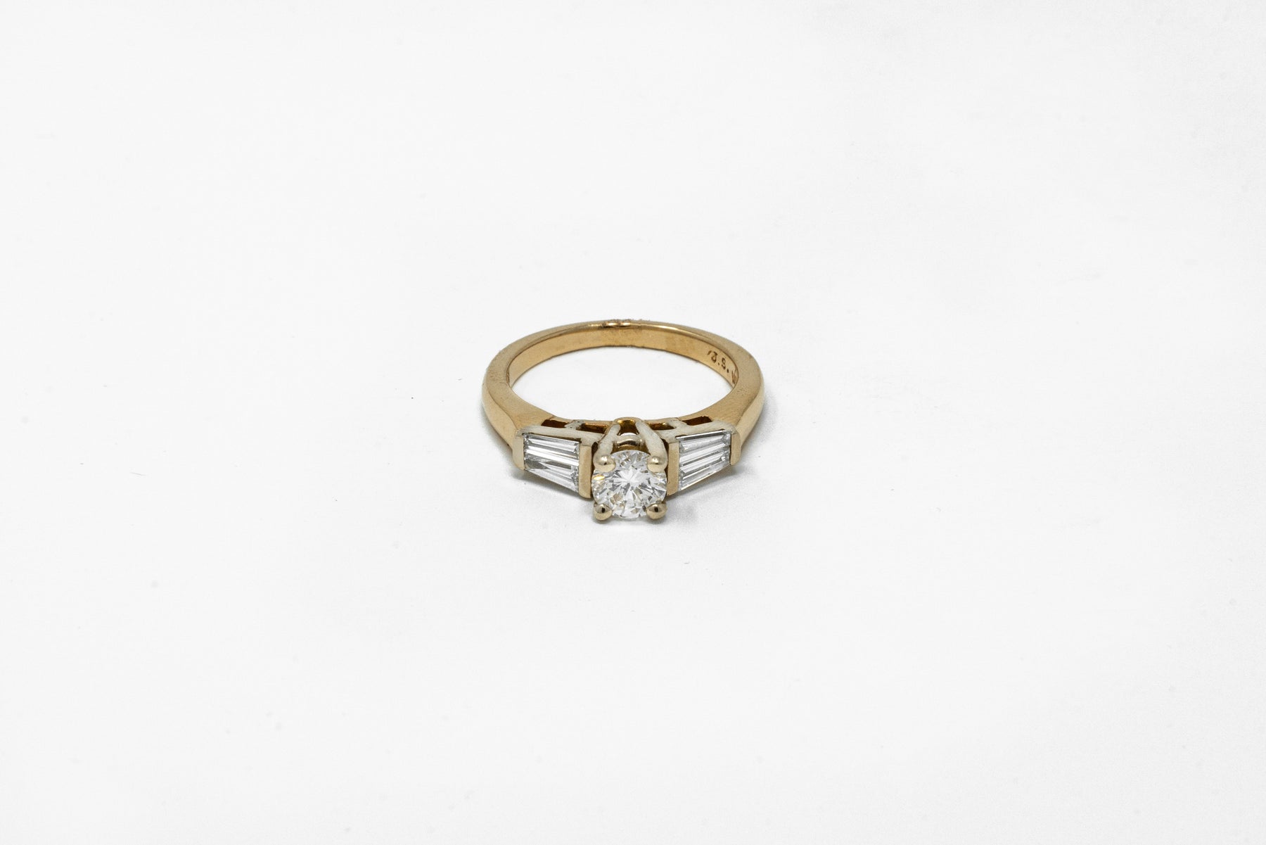 .57 point Round Brilliant Cut and .50 Tapered Baguette Diamond Ring