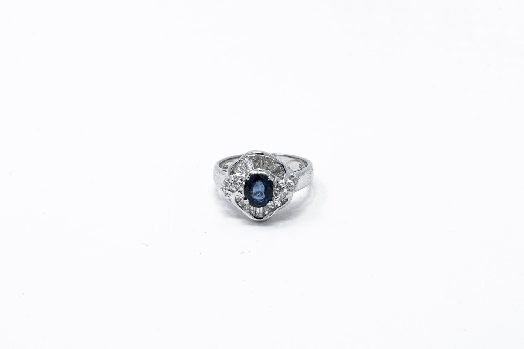 .60 point Oval Cut, .35 point Baguette Cut, and .15 point Round Brilliant Cut Diamond Ring