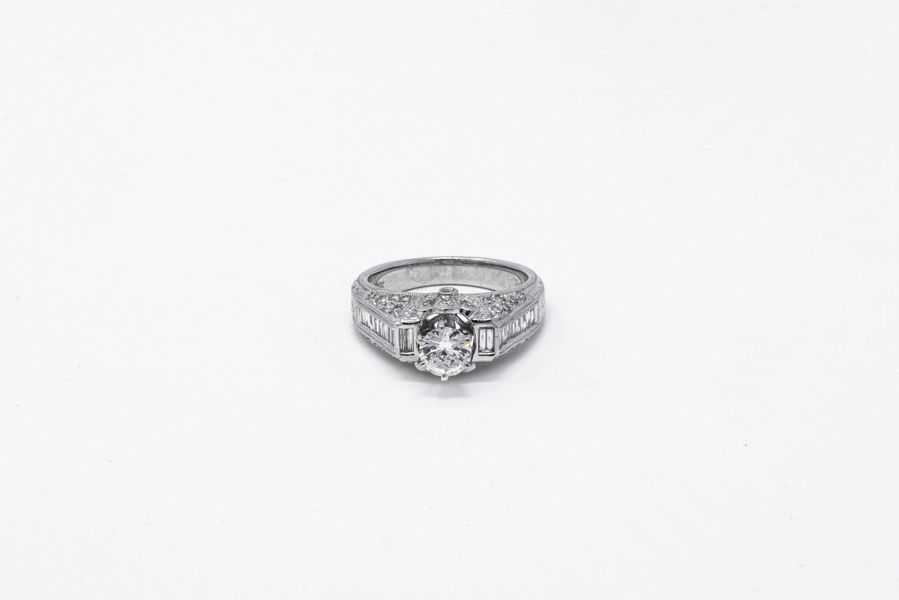 .58 point and .32 point Round Brilliant Cut and .14 point Tapered Baguette Cut Diamond Ring